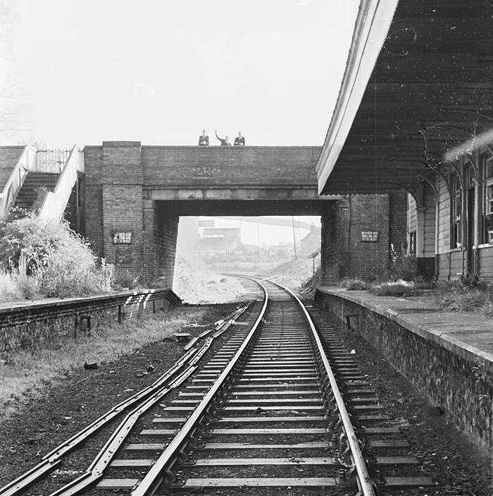 Looking along the single line through the road bridge towards Weedon with Southam Cement works seen in the distance