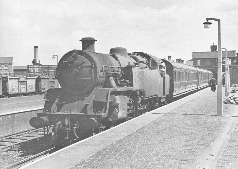 British Railways Standard Class 4MT 2-6-4T No 80039 stands at the down platform on the 12:42pm Coventry to New Street service in June 1959