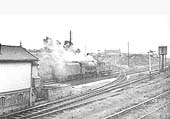 An unidentified ex-LMS 8F 2-8-0 locomotive propels a brake van past the Junction towards Foleshill station