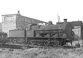 A very dirty ex-LNWR 7F 0-8-0 'G2', No 49417, is seen having being turned 270� on Milverton shed's single road turntable