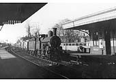 Ex-LNWR 0-6-0 No 8556 is seen passing through Warwick station whilst at the head of a short pick up working of Private Owner wagons in 1937
