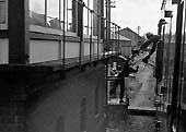The fireman exchanges tokens with the signalman on a Redditch to Ashchurch train in June 1962
