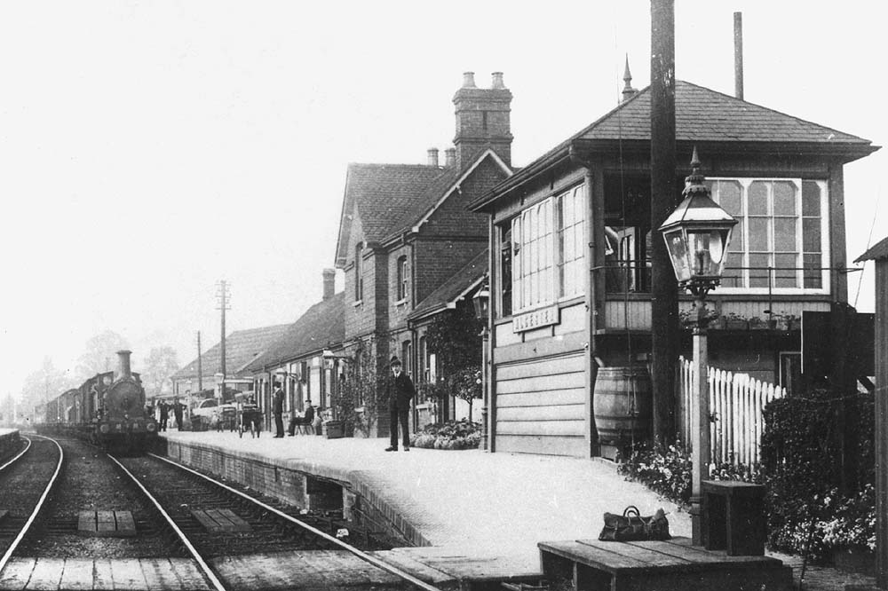 Close up showing the goods train being hauled by one of Kirtley's 0-6-0 locomotives whilst the signalman looks out of the signal box