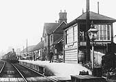 Close up showing the goods train being hauled by one of Kirtley's 0-6-0 locomotives whilst the signalman looks out of the signal box