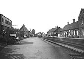 Looking towards Redditch along the up platform with the GWR's Bearley to Alcester branch auto trailer standing in the goods yard