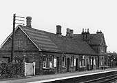Close up of the station with doors to the store, waiting rooms, bricked up door to the booking hall and office