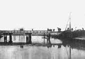Workman are rebuilding the final span on this girder bridge damaged by the storms and flood water of the winter of 1900-1901