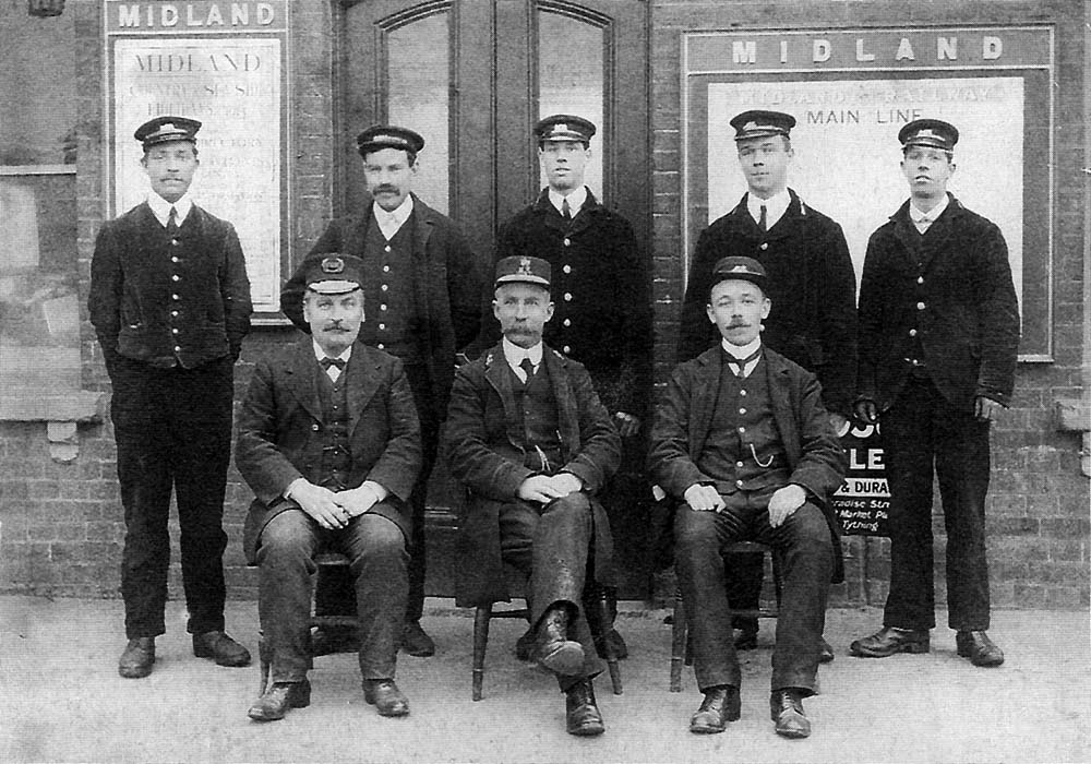 A posed photograph of Alcester station staff  with both the Great Western Railway and Midland Railway station masters present circa 1910