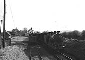 Ex-LMS 4F 0-6-0 No 44601 passes through the station on an up goods service on 20th April 1954