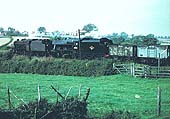 A pair of ex-LMS '8F' 2-8-0 locomotives are seen at the head of a coal train from a local pit near Arley & Fillongley