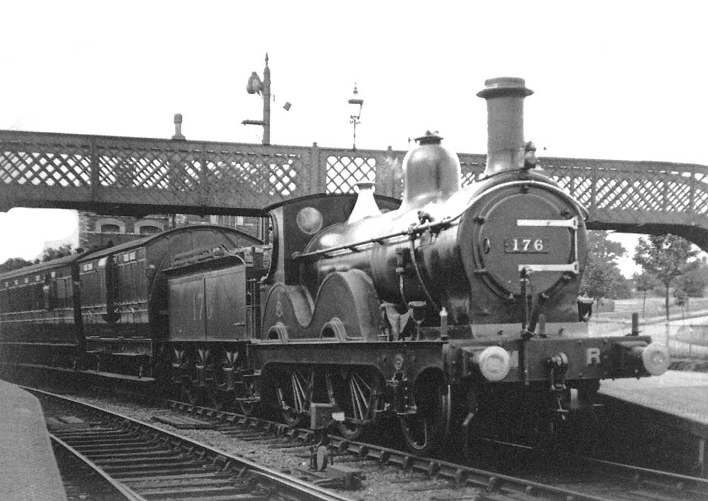 MR 2-4-0 No 176 on an up passenger train at Barnt Green with a Clayton four-wheel passenger third brake carriage behind the tender