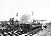 British Railways built 4MT 2-6-0 No 43036 is seen at the head of a down ordinary passenger service on 18th June 1953