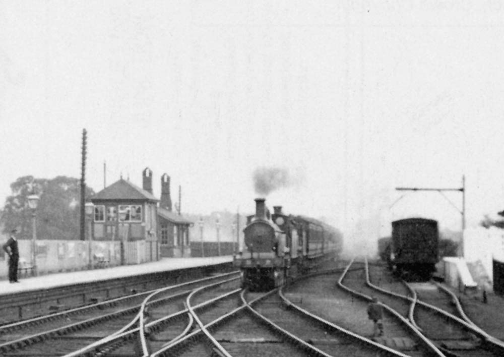 Close up showing a Bristol bound express train passes opposite the signal box hauled by two Johnson single locomotives