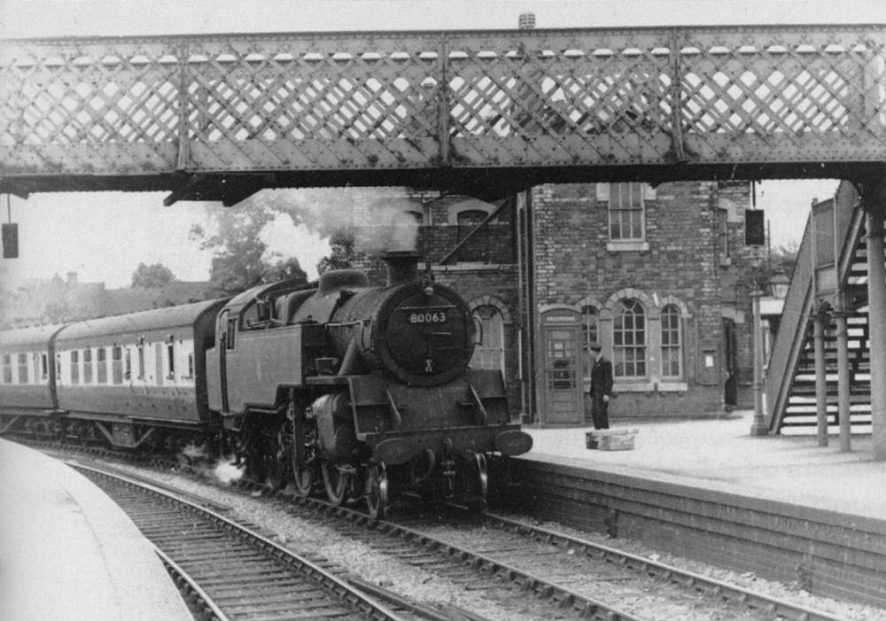 BR Standard 4MT 2-6-4T No 80063 arrives at the station on an Ashchurch to Birmingham New Street local passenger train