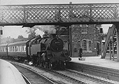 BR Standard 4MT 2-6-4T No 80063 arrives at the station on an Ashchurch to Birmingham New Street local passenger train