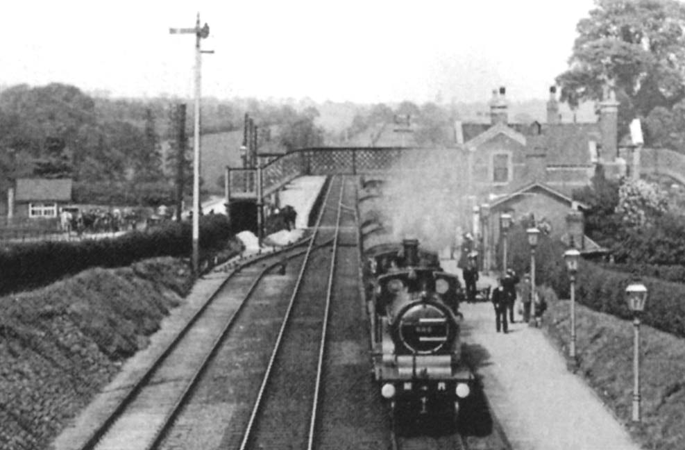 Close up showing MR 2-2-2 No 680 piloting an unknown member of the same class as it draws into the station