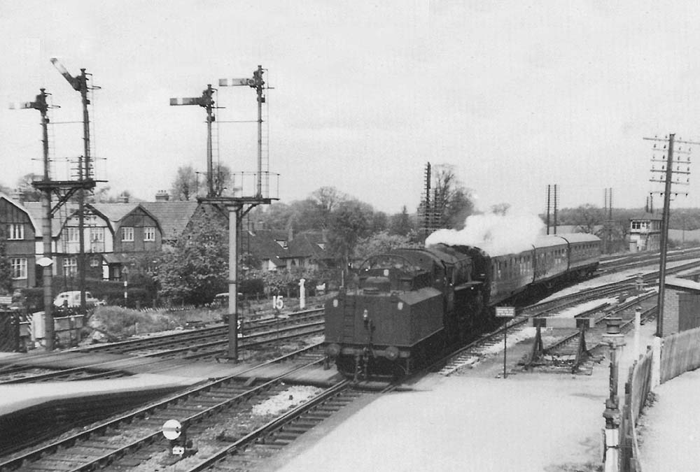 British Railways built Ivatt 2-6-0 No 43122 runs tender first into Barnt Green station's down branch platform on 11th May 1963