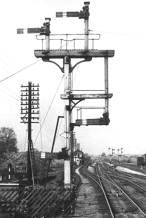 View of Barnt Green station's up main line bracket signal with co-acting arms