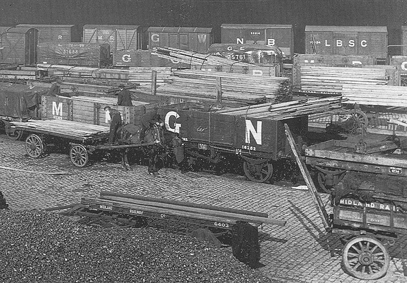 Close up showing the wide variety of the different railway company wagons that were typically to be found in a goods yard