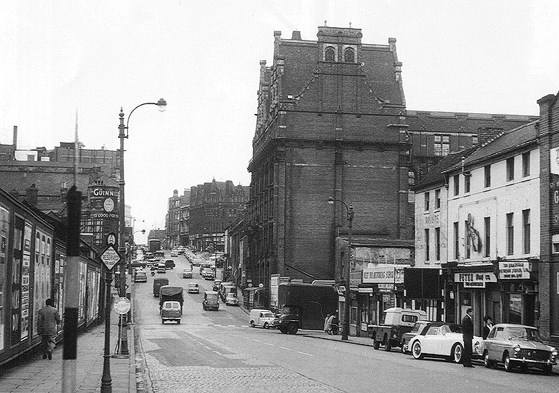 Looking along Suffolk Street with Birmingham Central Goods Depot behind the hoardings on the left and Matthew Bolton College of Technology towering on the right