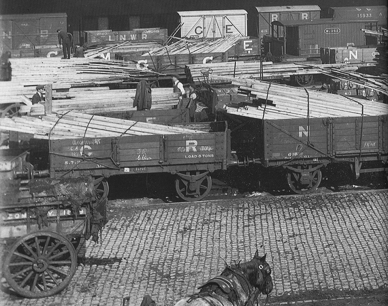 Close up showing the method of transporting timber planking utilising standard open railway wagons