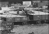 Close up showing the method of transporting timber planking utilising standard open railway wagons