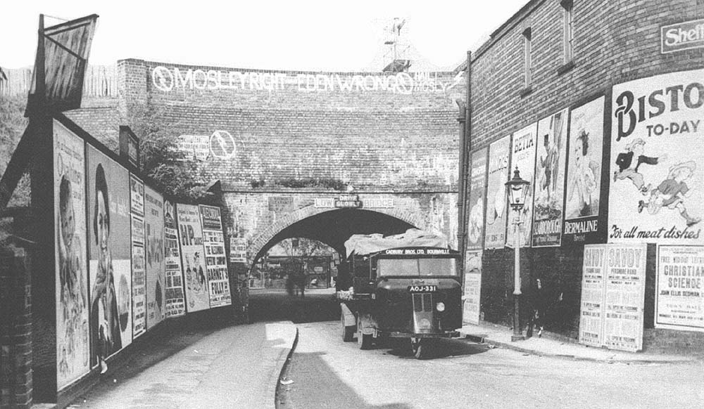 A Cadbury Brothers Scammell 'mechanical horse' passes beneath heavily graffitied Bournville Lane bridge in 1936