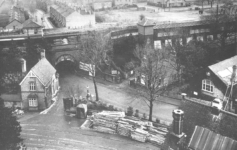 An elevated view showing the station's ground level booking office on the right and Station Lodge on the left