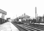 A view of a Cadburys seaside excursion train, standing at Bournville station's up platform in 1912