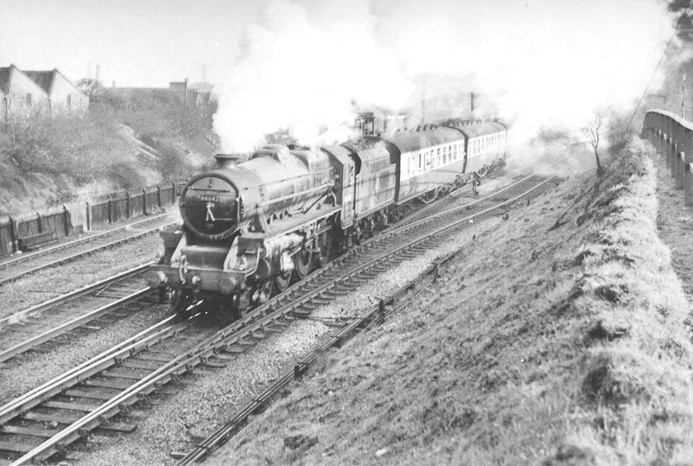 Ex-LMS 5MT 4-6-0 No 44842 runs along side the shed at the head of an Ian Allen Special on 16th April 1955