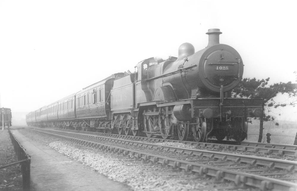 Ex-MR 4P 4-4-0 No 1025 photographed heading an eight coach train near Bournville on Wednesday 9th April 1930