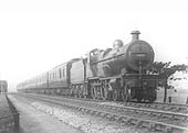 Ex-MR 4P 4-4-0 No 1025 photographed heading an eight coach train near Bournville on Wednesday 9th April 1930