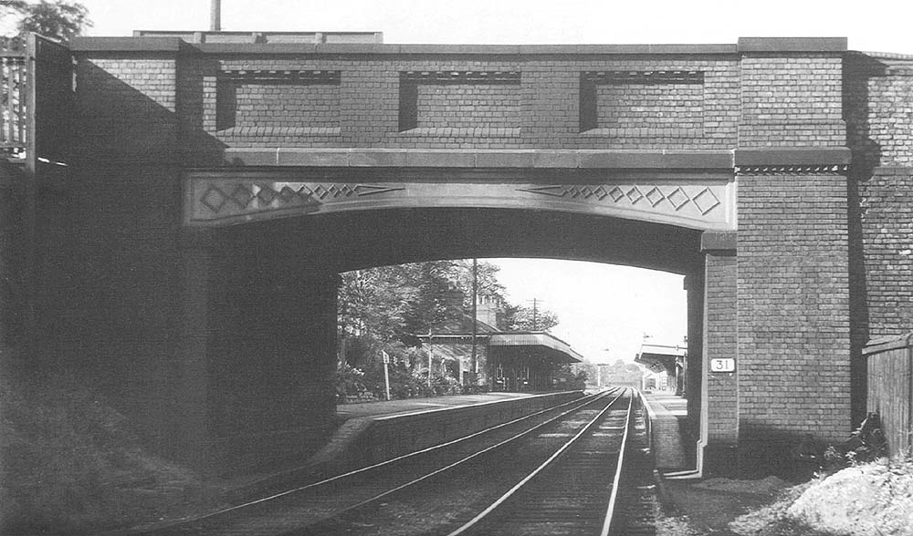 Bournville station, seen through the arch of the bridge carrying Maryvale Road, on Sunday 12th September 1954