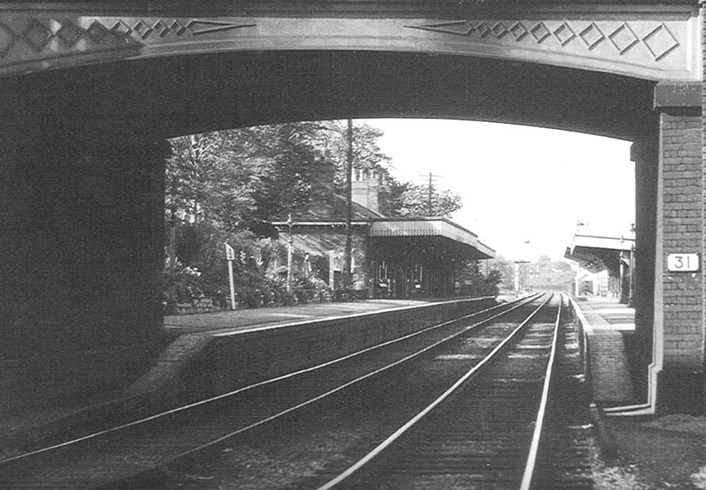 Close up of Bournville station, seen through the arch of the bridge carrying Maryvale Road, looking towards New Street station