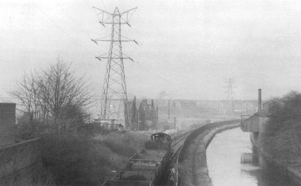 A view of the Lifford canal branch taken on Sunday 20th January 1957, with a train of empty wagons heading in the Bournville direction