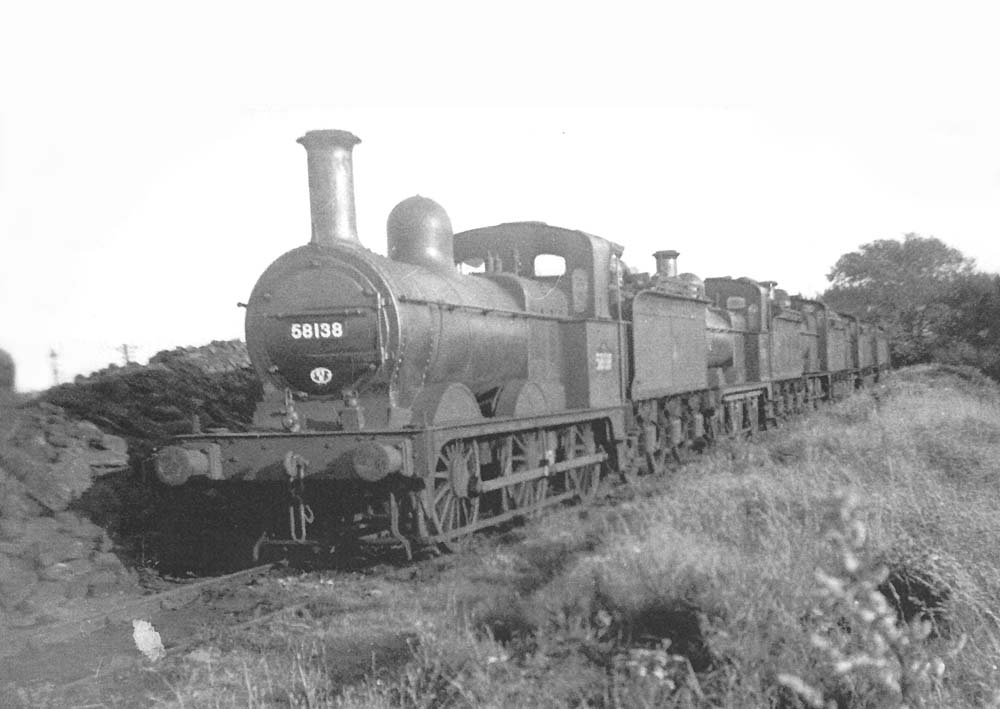 Ex-MR 2F 0-6-0 No. 58138 is seen at the head of a line of 0-6-0s on the siding adjoining Cotteridge Park in the fifties