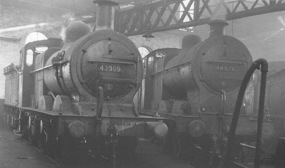Ex-MR 3F 0-6-0 No 43359 and ex-LMS 4F 0-6-0 No 44571 simmer in steam inside the shed during the late 1950s