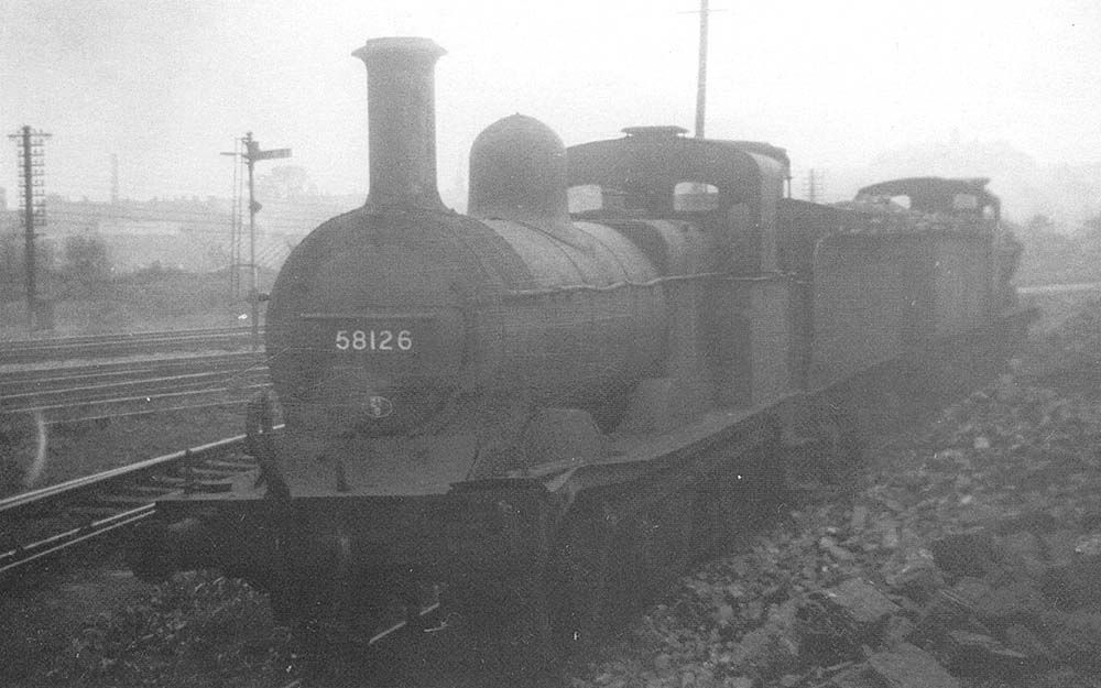 Withdrawn ex-MR 2F 0-6-0 No 58126 is seen on a short siding near the main line on Friday 1st June 1956