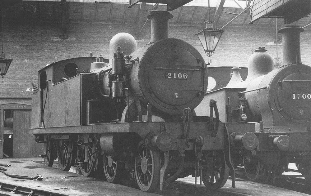 Ex-LTSR 2P 4-4-2T No 2106 stands inside the shed next to MR 0-6-0 'Johnson half-cab' No 1700 in June 1935