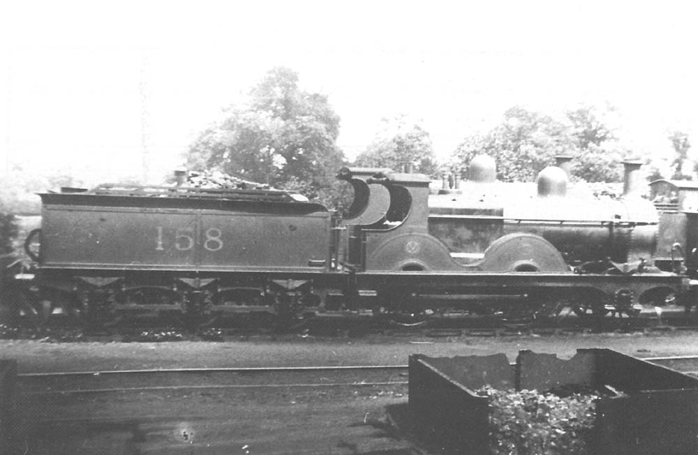 MR 1P 1282 class 2-4-0 No 158 has worked in from Gloucester on a local passenger train and seen at Bournville in 1921