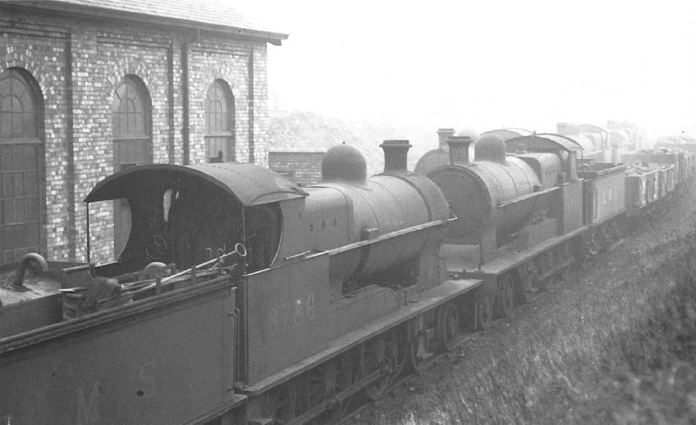 Ex-LNWR 4-6-0 19 inch goods No 8786, in store with other engines of the same type, beside the shed on 2nd March 1935