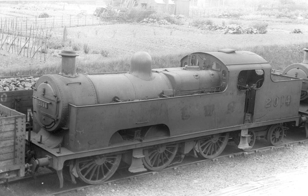 LMSR 3P 0-6-4T No 2014 stands on a siding next to allotments on Saturday 15th June 1935