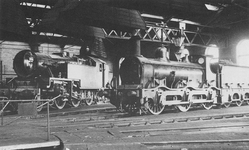 LMSR outside framed veteran No 22630 is 66 years older than No 2556, stabled nearby in the roundhouse at Bournville, in August 1936
