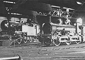 LMSR "ancient and modern", old 1F 0-6-0 No 22630 and new 4MT 2-6-4T No 2556, contrast strongly in the roundhouse at Bournville in August 1936