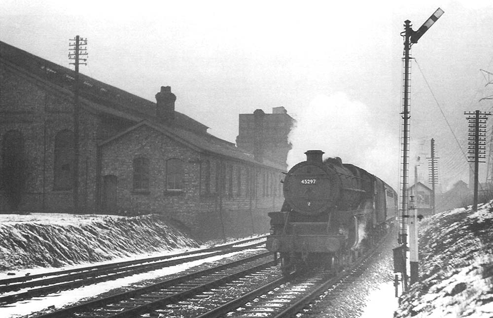 British Railways 5MT 4-6-0 No. 45297 passes Bournville shed as it heads southwards on the cold morning of Sunday 19th February 1956