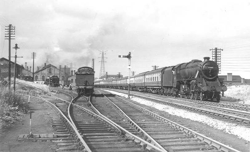 Ex-LMS 5MT 4-6-0 No 44813 heads at least eleven coaches southwards past Bournville shed on 5th September 1955