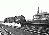 Ex-LMS 5F6P 2-6-0 'Hughes Crab' No 42823 runs past Bromford Bridge Signal Box hauling an unidentified ex-LMS 8F 2-8-0 locomotive