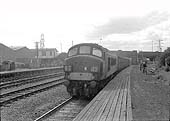 An unidentified Sulzer Type 4 locomotive passes Bromford Bridge's up platform with a short train of vans