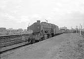 Ex-LMS 8F 2-8-0 No 48279 proceeds past the down platform on a Class F express freight service