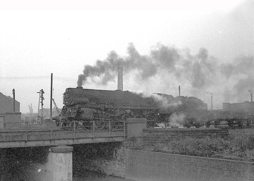 An unidentified former Franco-Crosti boilered 8F 2-10-0 locomotive passes over the River Tame with a Class F express freight service